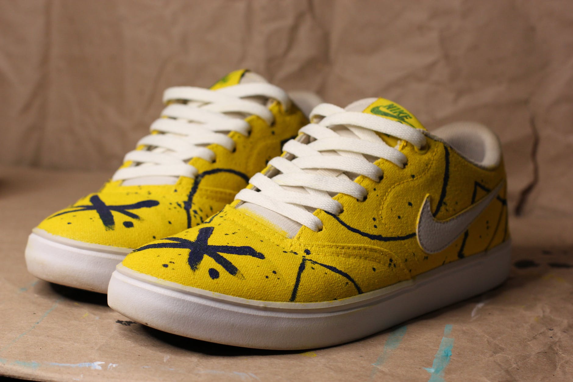 close up photo of yellow nike shoes